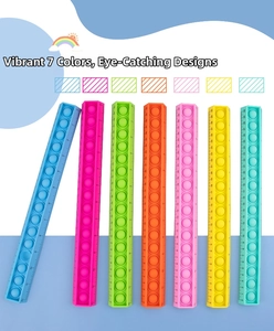 Row of seven colorful silicone pop-it sensory rulers showing clear 0-30cm scales