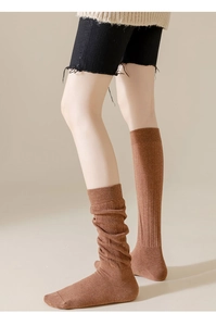 Détail de chaussettes hautes marron en maille avec texture coton épaisse et style souple