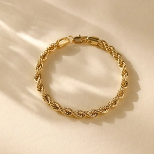 Macro view showing the 14K gold plated twisted rope chain texture and polished finish