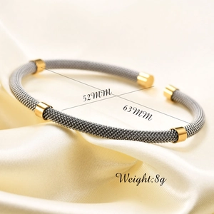 Detail of cable wire bangle showing internal diameter dimensions of 52mm and 63mm