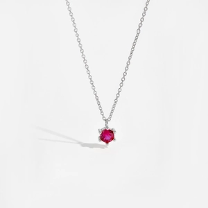 Detailed macro shot of a red round-cut zircon pendant on an S925 silver chain
