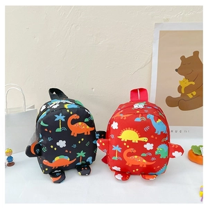 Detail of cute cartoon dinosaur backpacks in red and black colors for toddlers