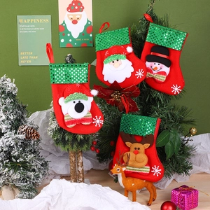 Detail of colorful Christmas stockings with Santa and snowman hanging on a tree