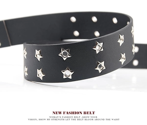 Close-up of black leather belt featuring double-row star-shaped metal eyelets in punk style