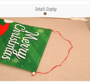 Detail view of green Christmas banner with white Merry Christmas text and snowflake patterns