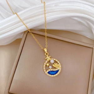 Detail of gold necklace pendant with blue enamel wave, star, and pearl inlay
