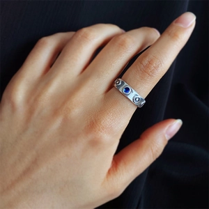 Macro detail of silver vintage flower ring featuring a round blue stone in a retro setting