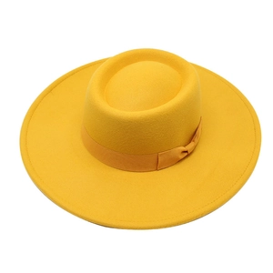 Top view of a bright yellow wide-brimmed wool felt fedora hat with matching silk ribbon
