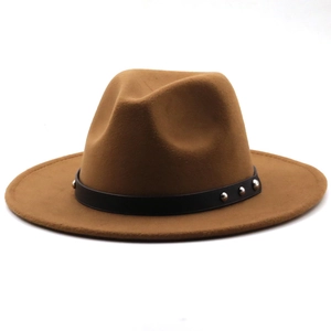 Detail of tan fedora hat featuring black leather band and silver metal rivets