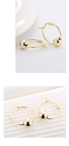 Detail view of 14K gold plated silver hoop earrings with polished sliding beads