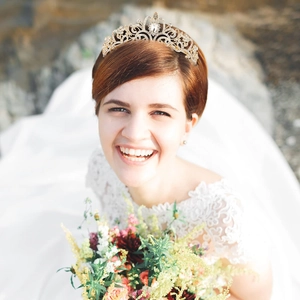 Close-up of a golden bridal tiara with sparkling rhinestones worn as a wedding headpiece