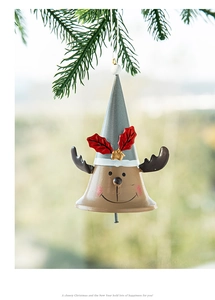 Detail of hanging metal reindeer bell ornament with grey hat and red berry accents