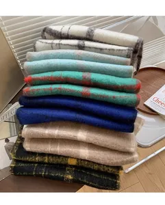 Stack of colorful plaid mohair-style scarves with warm brushed texture in various patterns