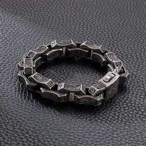 Macro shot of 304 stainless steel bracelet with carved vintage wave patterns on black leather