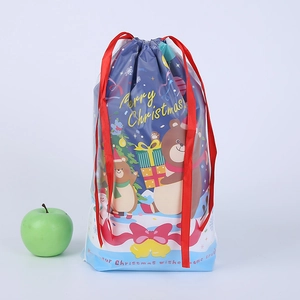 Detailed view of Christmas drawstring gift bags with cartoon bear and ribbon closure