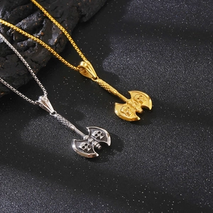Detail of punk style skull axe pendants in gold and silver finish with box chains