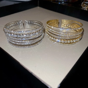 Macro shot of sparkling multi-layer rhinestone open bracelets with light reflection stars