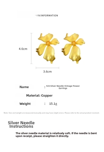 Macro view of matte gold flower earrings detailing 4.6cm height and 3.6cm width dimensions