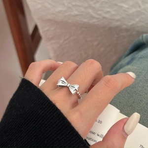 Elegant 925 sterling silver bow knot ring with twisted band design shown on finger