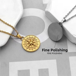 Macro shot of gold and silver compass necklaces featuring fine polishing and relief detail