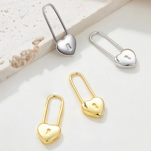 Detailed close-up showing the 925 silver hallmark on heart-shaped lock earrings
