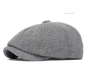 Close-up of grey tweed newsboy cap showing detailed wool blend knit and retro octagonal texture