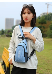 Detail of light blue mini backpack with side mesh pocket and adjustable shoulder strap