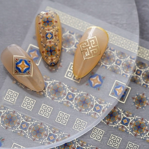Golden geometric and vintage floral nail art stickers on nude manicure nails