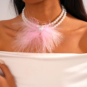 Detail of pink feather fringe and oversized pearl on a double-layer Baroque necklace