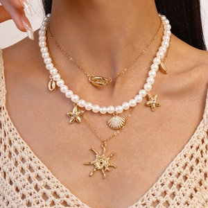 Three-layer gold necklace with starfish, seashell, and pearl pendants for beach vacations