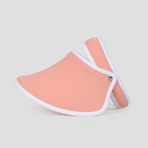 Detailed view of pink sun visor hat with white trim and foldable rolling design