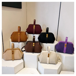 Collection of retro shell bags in seven colors displayed on geometric stands