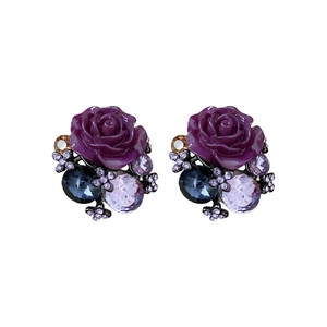 Vintage style purple resin flower earrings with blue and clear crystals on white background