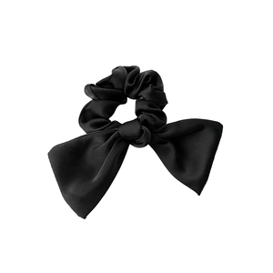 Elegant black satin hair scrunchie with large bow ornament shown on a clean white background