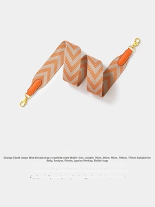 Detail of 5cm wide orange herringbone woven strap with gold clasps and leather ends