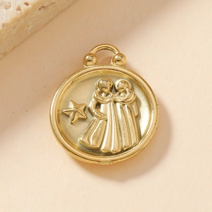 Macro shot of 18K gold stainless steel Gemini zodiac pendant with embossed relief art