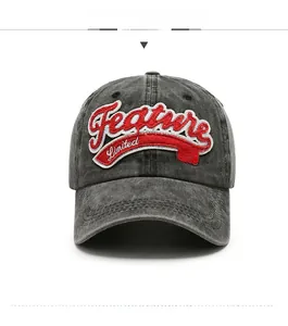 Close-up of vintage washed denim baseball cap with red 3D embroidery and distressed brim