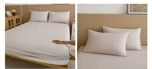 Detail of warm beige fitted sheet and pillowcase with soft texture on a mattress