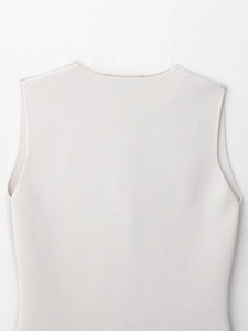 Detailed view of the fine knit texture and neckline of the beige sleeveless vest top
