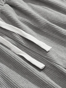 Detail of grey corduroy fabric texture featuring white drawstring on casual men sportswear