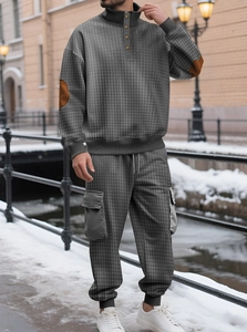 Détail de l'ensemble gris foncé montrant la texture quadrillée et les coudières brunes