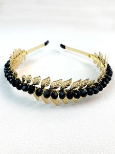 Detailed view of handmade gold leaf headband with faceted black crystal beads