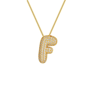 Detailed close-up of an 18K gold plated necklace with a large zircon encrusted letter F pendant