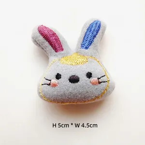 Detail view of 5cm grey rabbit plush patch with colorful ear embroidery for DIY crafts