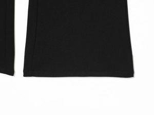 Close-up of double-stitched hem and high-density fabric texture on black pants