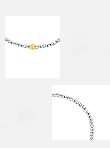Detail of s925 silver beaded bracelet with a frosted gold bead showing matte texture