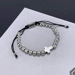 Detail of adjustable black cord bracelet with silver beads and cross pendant