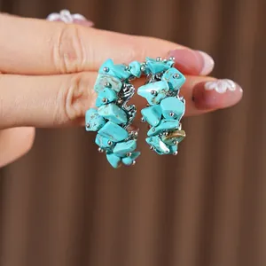 Silver C-shape hoop earrings with turquoise stones and geometric crinkle metal design