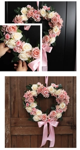 Detail of heart-shaped pink and beige faux rose wreath with elegant satin ribbons