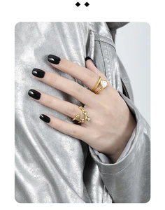 Detail of gold layered open rings with baroque pearl on silver irregular fluid band